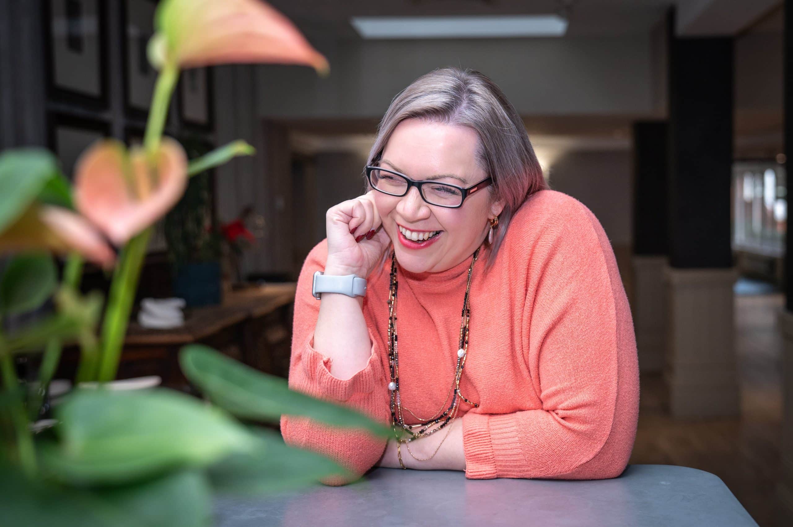 Holly Nixon sat a desk smiling
